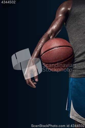 Image of The hands of a basketball player with ball
