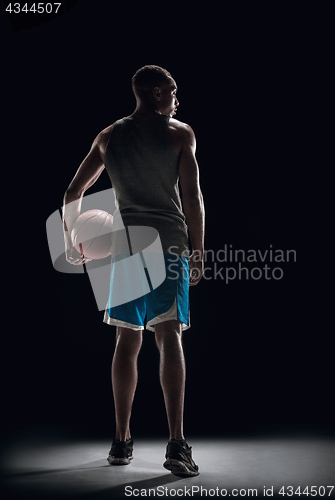 Image of The back of a basketball player with ball