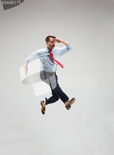 Image of Businessman running on gray background