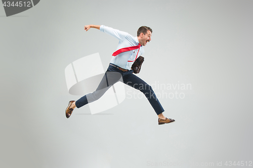 Image of Businessman running with a briefcase, isolated on gray background