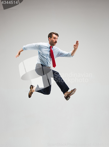Image of Businessman running on gray background
