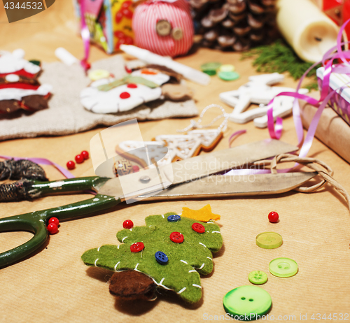 Image of lot of stuff for handmade gifts, scissors, ribbon, paper with countryside pattern, ready for holiday concept, nobody home 