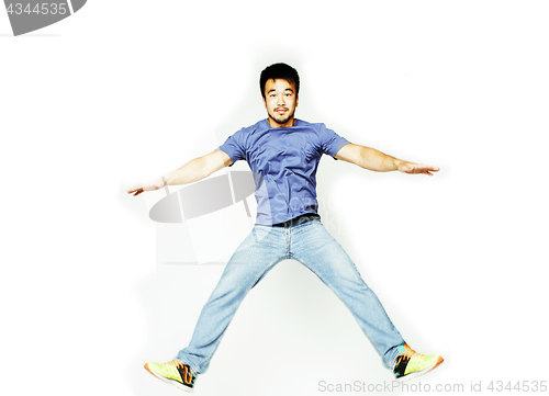 Image of young pretty asian man jumping cheerful against white background