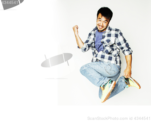 Image of young pretty asian man jumping cheerful against white background