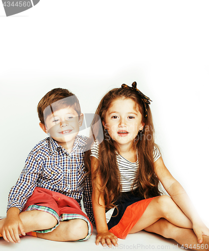 Image of little cute boy and girl hugging playing on white background, ha