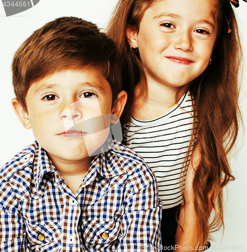 Image of little cute boy and girl hugging playing on white background, ha