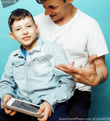 Image of young pretty man model with little cute son playing together, lifestyle modern people concept, family male 
