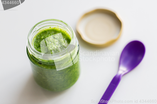 Image of jar of vegetable puree or baby food and spoon