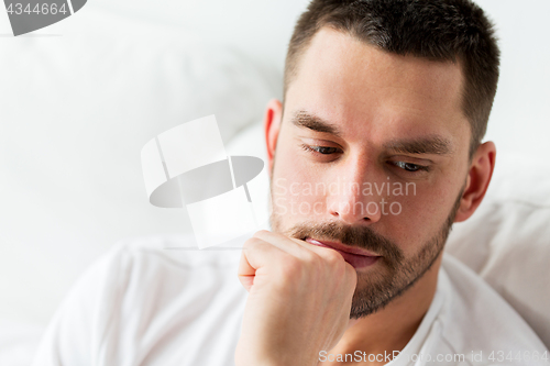 Image of close up of man in bed thinking