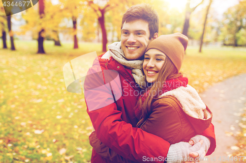 Image of happy young couple hugging in autumn park
