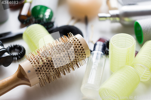Image of curling hair brush, styling spray and curlers