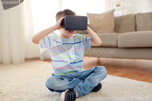 Image of little boy in vr headset or 3d glasses at home