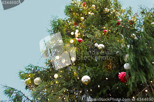 Image of close up of fir with christmas tree toys outdoors