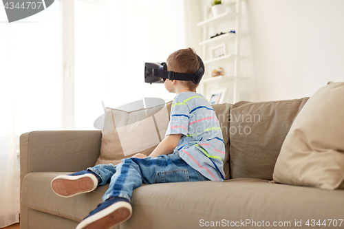 Image of little boy in vr headset or 3d glasses at home