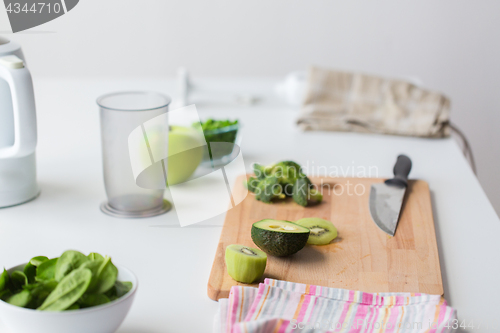 Image of green fruits and vegetables on kitchen table