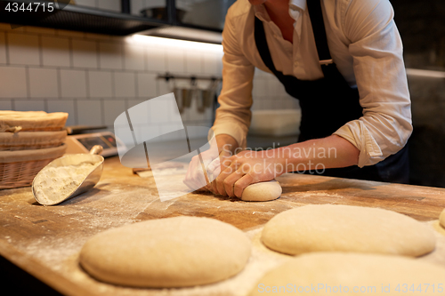 Image of baker making bread dough at bakery kitchen