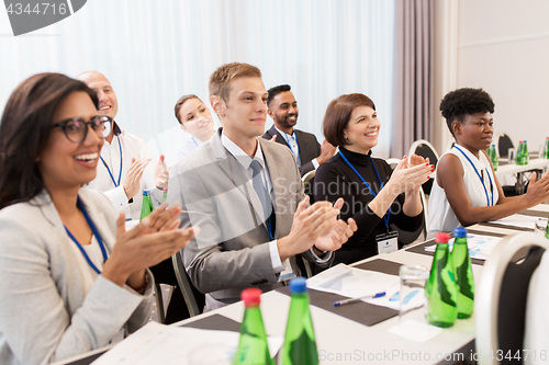 Image of people applauding at business conference