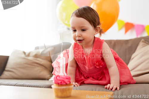 Image of baby girl with birthday cupcake at home party