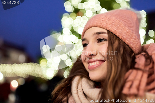 Image of happy young woman at christmas market in winter