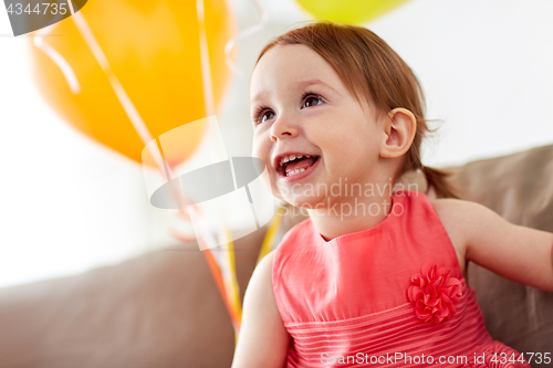 Image of happy baby girl on birthday party at home