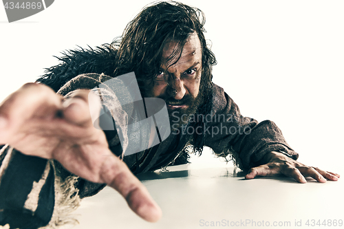 Image of Portrait of a brutal bald-headed viking in a battle mail posing against a white background.