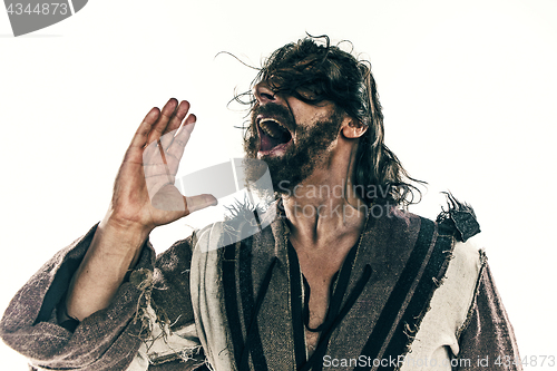 Image of Portrait of a brutal bald-headed viking in a battle mail posing against a white background.