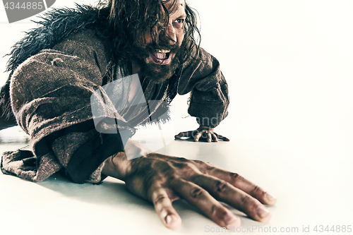 Image of Portrait of a brutal bald-headed viking in a battle mail posing against a white background.