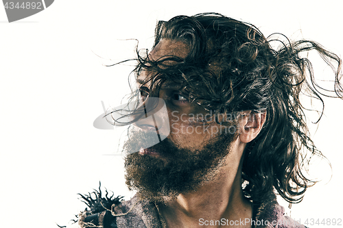 Image of Portrait of a brutal bald-headed viking in a battle posing against a white background.