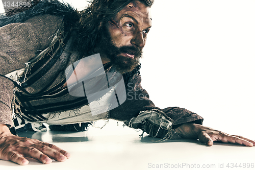 Image of Portrait of a brutal bald-headed viking in a battle mail posing against a white background.