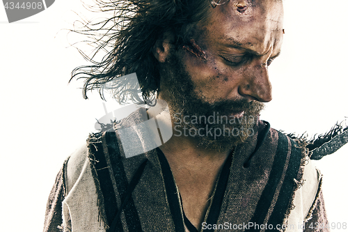 Image of Portrait of a brutal bald-headed viking in a battle mail posing against a white background.