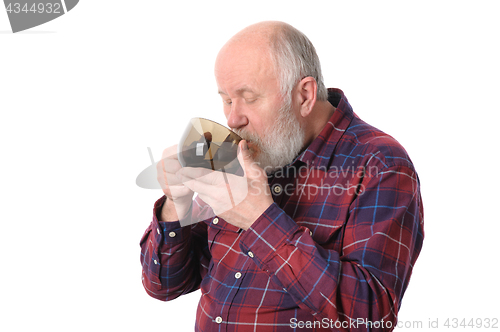 Image of senior man drinking from cup, isolated on white