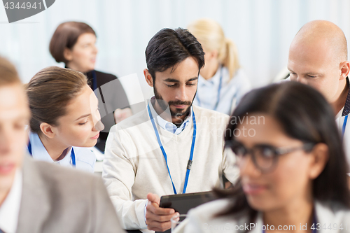 Image of team with tablet pc at business conference