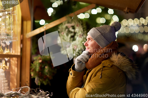 Image of happy man looking at christmas market shop window