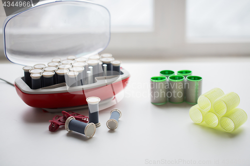 Image of hair curlers and hot rollers kit on table