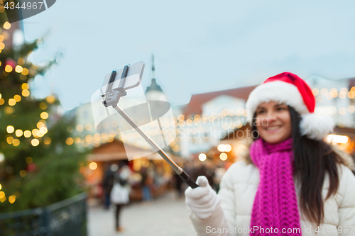 Image of woman taking selfie with smartphone at christmas 