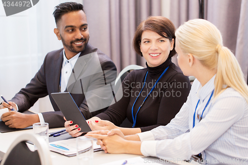 Image of team with tablet pc at business conference