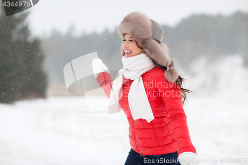 Image of happy woman in winter fur hat outdoors