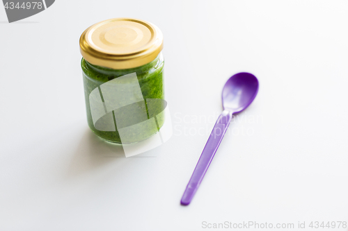 Image of jar of vegetable puree or baby food and spoon