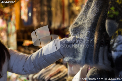 Image of woman buying woolen socks at christmas market