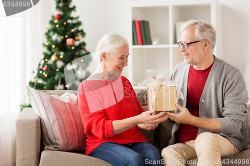 Image of happy smiling senior couple with christmas gift