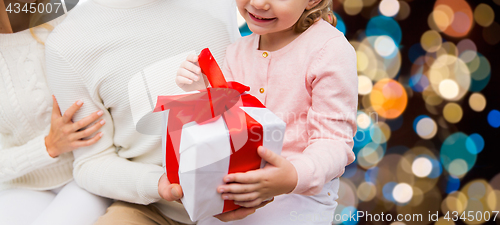 Image of happy family at home with christmas gift box