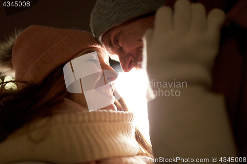 Image of close up of happy couple in winter clothes