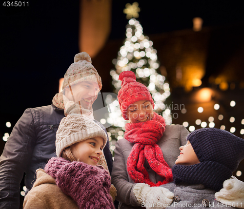 Image of happy family outdoors at christmas eve
