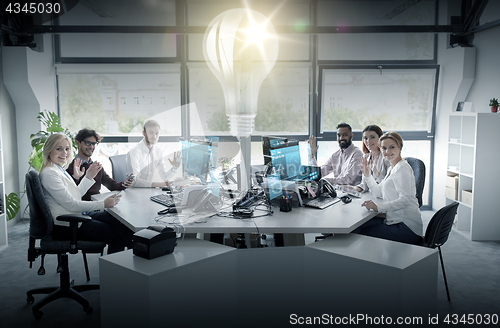 Image of business team waving hands at office