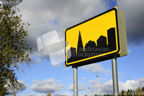 Image of road sign settlement on the sky background