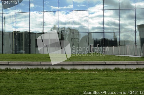 Image of green lawn and glass facade of a modern building