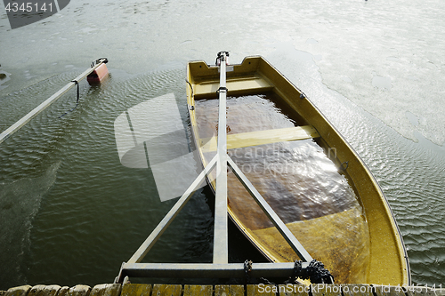 Image of a boat flooded with water at the pier