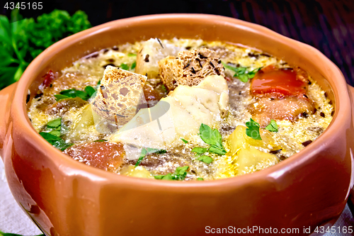 Image of Soup fish with vegetables and cream on dark board