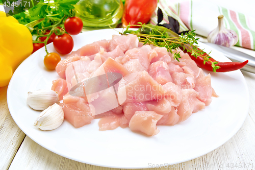 Image of Chicken breast raw sliced in plate on light board