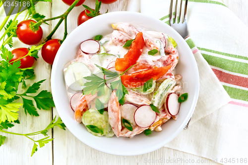 Image of Salad from fresh vegetables in plate on board top